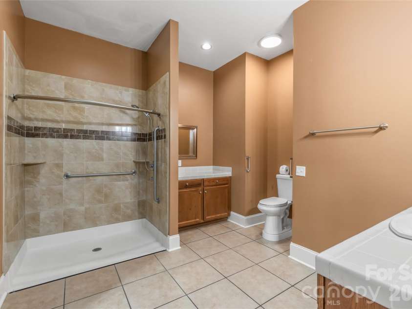 424 Rollingbrook Road, Kings Mountain, NC 28086.  MLS# CAR4318684, YatesRealty ID 3237. Full bathroom with tiled shower, grab bars, single vanity, and tile flooring.