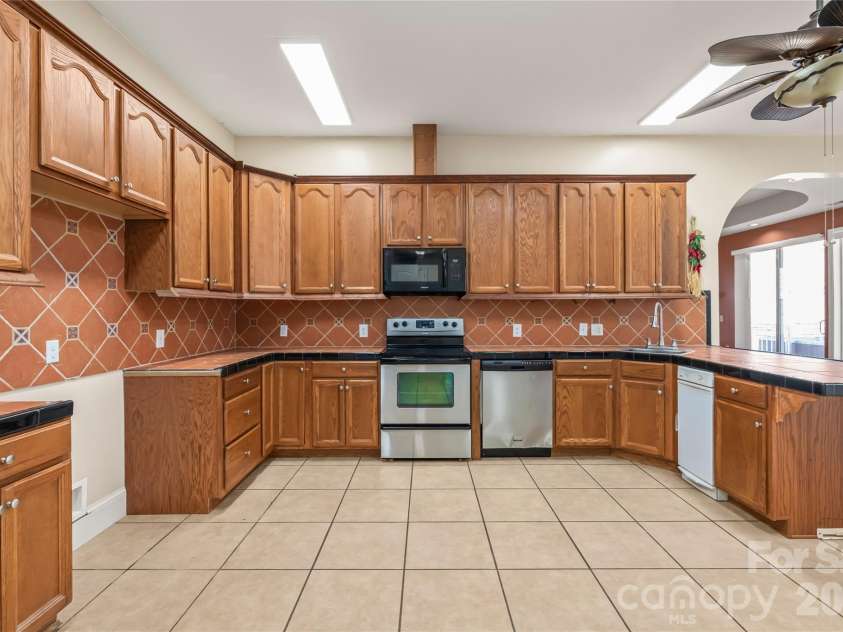 424 Rollingbrook Road, Kings Mountain, NC 28086.  MLS# CAR4318684, YatesRealty ID 3237. Kitchen featuring stainless steel range, microwave, dishwasher, and extensive counter space.