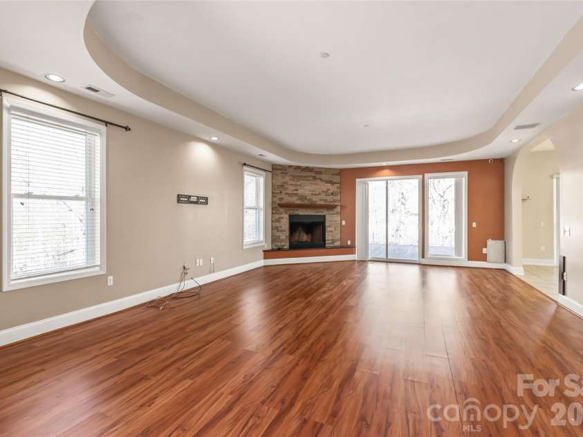 424 Rollingbrook Road, Kings Mountain, NC 28086.  MLS# CAR4318684, YatesRealty ID 3237. Living area featuring stone fireplace and sliding doors to rear deck.