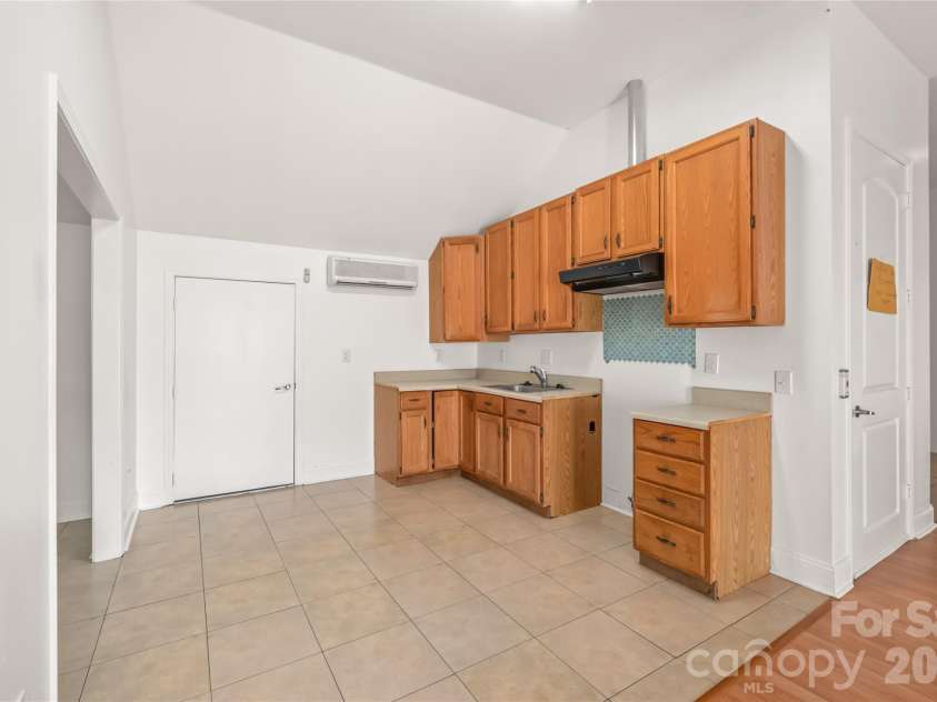 424 Rollingbrook Road, Kings Mountain, NC 28086.  MLS# CAR4318684, YatesRealty ID 3237. Upper-level kitchenette with cabinetry, sink, and tile flooring.