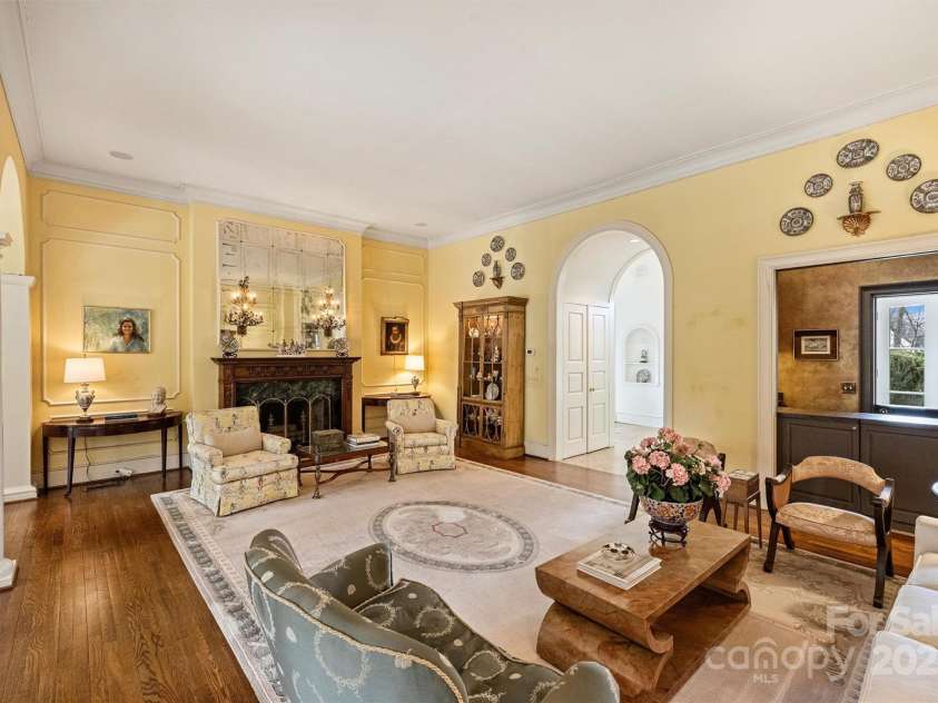 318 Canterbury Road, Charlotte, NC 28211.  MLS# CAR4231857, YatesRealty ID 3238. Here, an English carved mantle with a marble surround graces the wood-burning fireplace, complemented by intricate beaded crown molding and paneled walls.