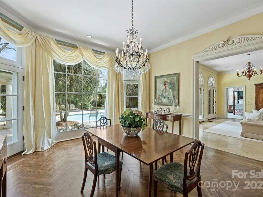 318 Canterbury Road, Charlotte, NC 28211.  MLS# CAR4231857, YatesRealty ID 3238. The dining room showcases exquisite French parquet flooring and floor-to-ceiling bay windows.