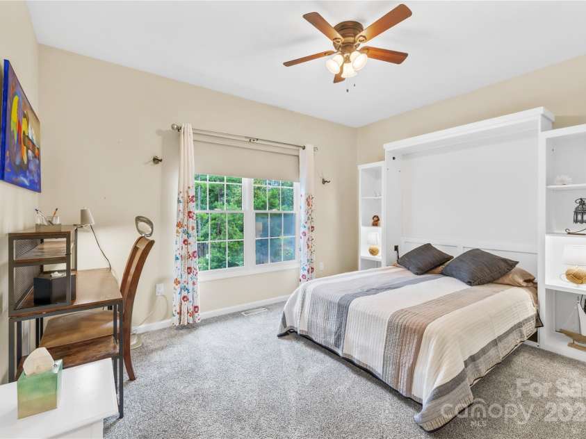 22312 John Gamble Road, Cornelius, NC 28031.  MLS# CAR4289564, YatesRealty ID 32384. This is the other secondary bedroom facing the back of the house. Murphy bed w/shelving conveys with the home