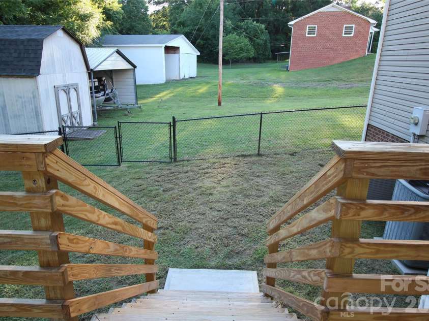 1034 Arrowhead Drive, Concord, NC 28025.  MLS# CAR4394849, YatesRealty ID 32388. Looking into the side yard