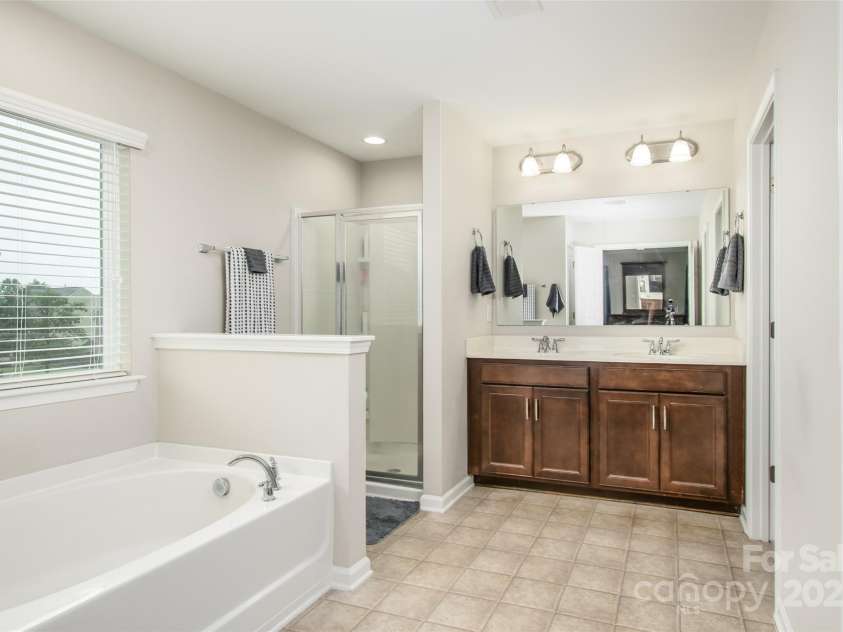 128 Millen Drive, Mooresville, NC 28115.  MLS# CAR4318597, YatesRealty ID 32390. Looking in to Primary bathroom