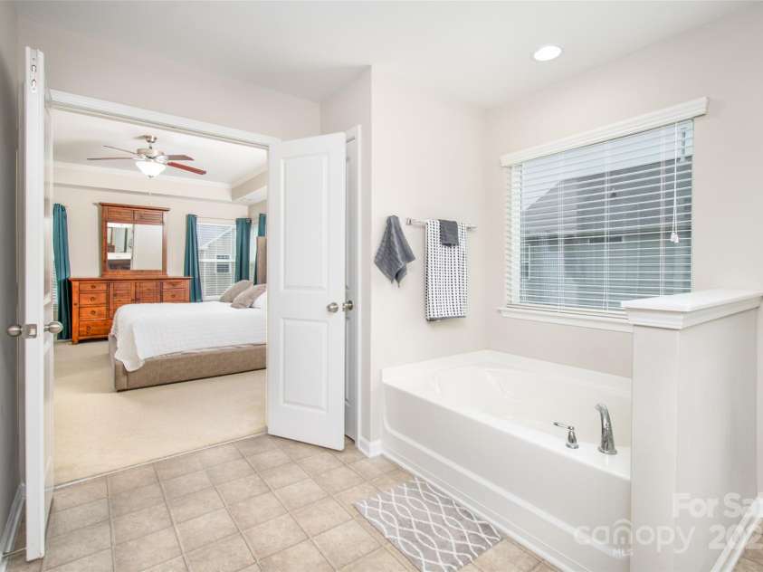 128 Millen Drive, Mooresville, NC 28115.  MLS# CAR4318597, YatesRealty ID 32390. Looking in to Primary bedroom