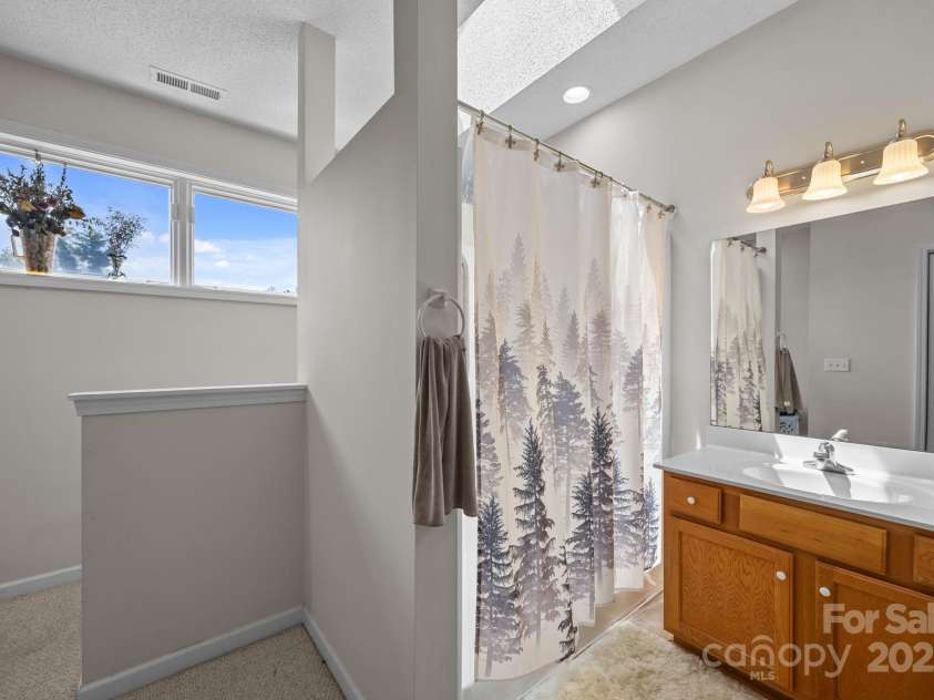 8 Beekeeper Trail, Swannanoa, NC 28778.  MLS# CAR4280414, YatesRealty ID 32396. Ensuite bathroom upstairs -bright and open