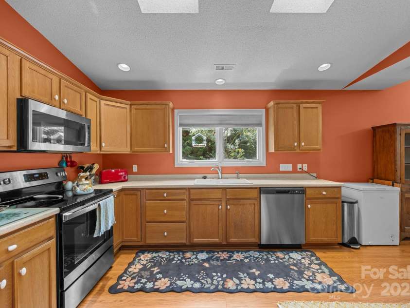 8 Beekeeper Trail, Swannanoa, NC 28778.  MLS# CAR4280414, YatesRealty ID 32396. Kitchen window looks out to the backyard-