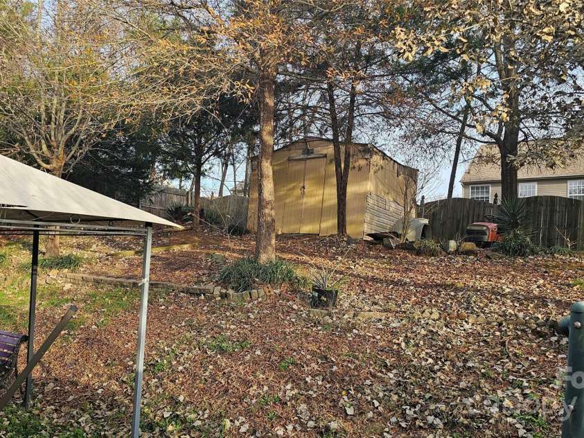 6334 Dillard Ridge Drive, Charlotte, NC 28216.  MLS# CAR4206693, YatesRealty ID 324. A picture of the back yard and the scope of the enclosure of the fencing. 