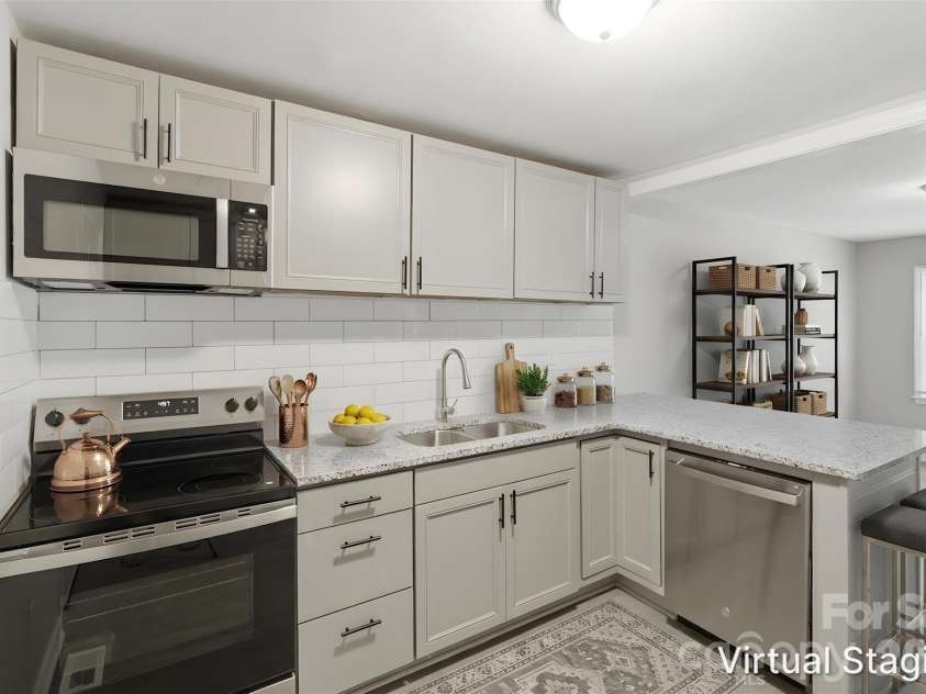 2732 Thornton Road, Charlotte, NC 28208.  MLS# CAR4394385, YatesRealty ID 32403. Your new kitchen!! Upgrades include granite counters, SS appliances (includes dishwasher, electric range & microwave), shaker-style cabinets, subway tile backsplash & SS dual deep sink (virtually staged & enhanced).