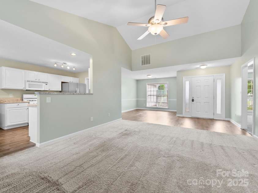 42 Morning Mist Road, Fletcher, NC 28732.  MLS# CAR4292025, YatesRealty ID 32410. Looking from the gas fireplace, you can see the dining area with large window and great natural light.