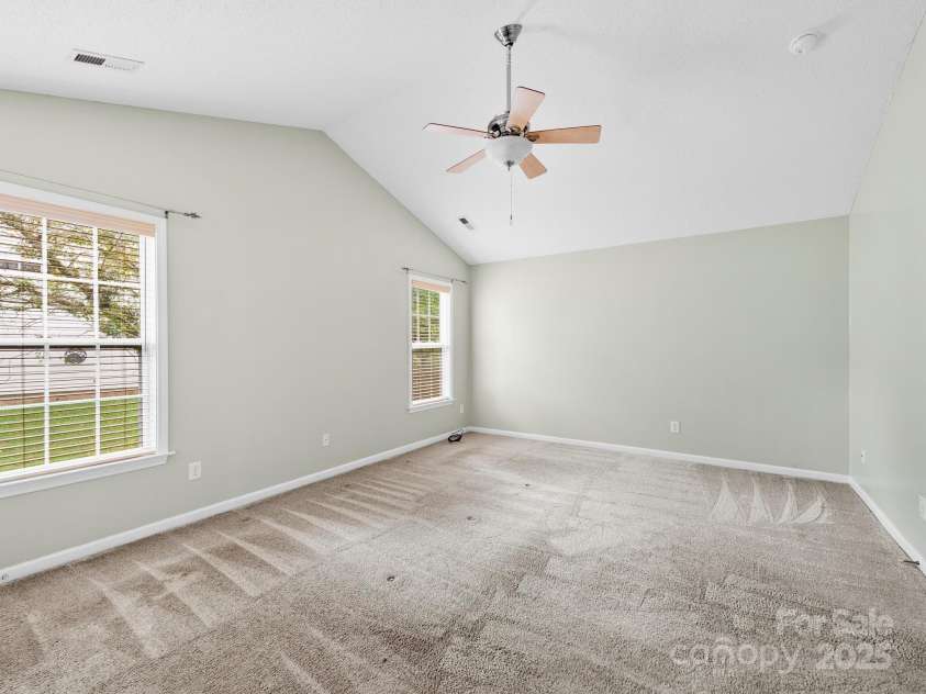 42 Morning Mist Road, Fletcher, NC 28732.  MLS# CAR4292025, YatesRealty ID 32410. Spacious primary bedroom with vaulted ceilings, walk in closet and ensuite bathroom.