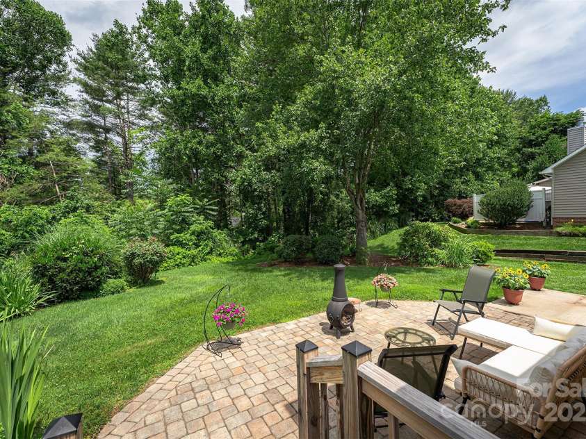 330 Stonehollow Road, Fletcher, NC 28732.  MLS# CAR4271829, YatesRealty ID 32415. Sweet patio with a wooded view