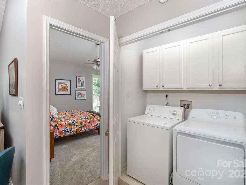 330 Stonehollow Road, Fletcher, NC 28732.  MLS# CAR4271829, YatesRealty ID 32415. The laundry closet is nestled between the primary bedroom that you see on the left and a spacious closet on the right. The laundry is hidden from view by two full size doors.