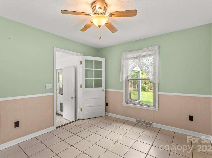 2423 Warrior Fork Trail, Morganton, NC 28655.  MLS# CAR4285223, YatesRealty ID 32420. Exit this dining area to the mud/laundry room and screened and four seasons porches and garage