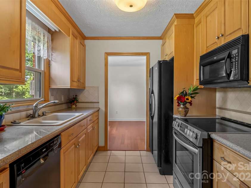 2423 Warrior Fork Trail, Morganton, NC 28655.  MLS# CAR4285223, YatesRealty ID 32420. Kitchen offers great views of the expansive yard and garden.