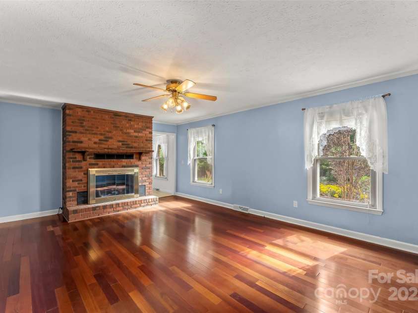2423 Warrior Fork Trail, Morganton, NC 28655.  MLS# CAR4285223, YatesRealty ID 32420. Living room on front of home features gas log fireplace