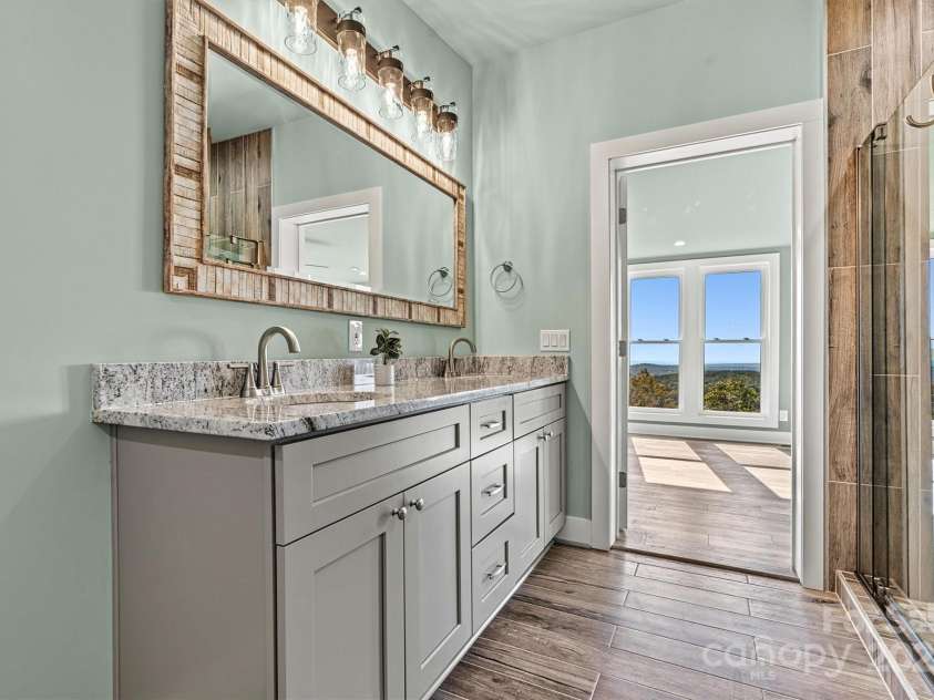 6230 Pine Ridge Drive, Connelly Springs, NC 28612.  MLS# CAR4194799, YatesRealty ID 3243. Primary en-suite with large walk in closet and beautiful tile shower and dual vanities with gorgeous granite.