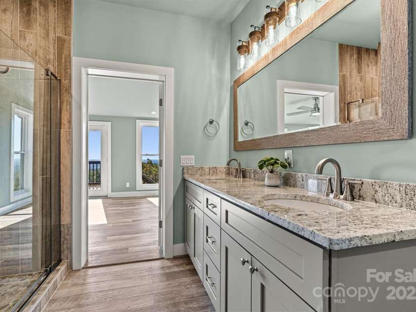 6230 Pine Ridge Drive, Connelly Springs, NC 28612.  MLS# CAR4194799, YatesRealty ID 3243. Primary en-suite with large walk in closet and beautiful tile shower and dual vanities with gorgeous granite.