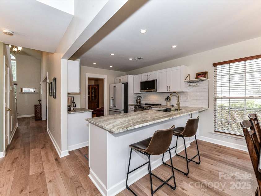 5461 Coleman Circle, Concord, NC 28027.  MLS# CAR4291828, YatesRealty ID 32431. Gorgeous, Freshly Painted Kitchen newly renovated in 2023 with leather granite countertops, soft close shaker cabinets, subway tile backsplash and high end LG appliances.