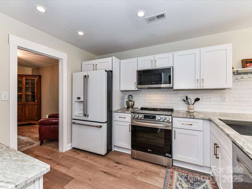 5461 Coleman Circle, Concord, NC 28027.  MLS# CAR4291828, YatesRealty ID 32431. Gorgeous, Freshly Painted Kitchen newly renovated in 2023 with leather granite countertops, soft close shaker cabinets, subway tile backsplash and high end LG appliances.