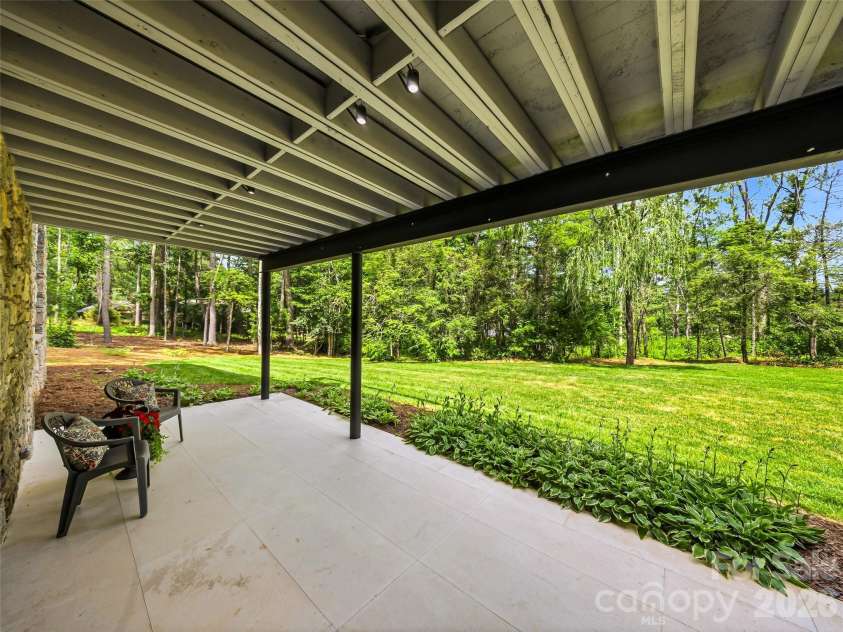 3 Holly Hill Road, Biltmore Forest, NC 28803.  MLS# CAR4396733, YatesRealty ID 32435. A sheltered lower loggia patio for entertaining and enjoying the expansive yard.