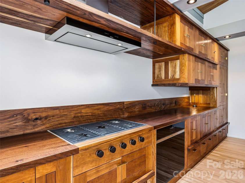 3 Holly Hill Road, Biltmore Forest, NC 28803.  MLS# CAR4396733, YatesRealty ID 32435. Custom, handmade book-matched horizontal grain walnut millwork is breathtaking in this kitchen.