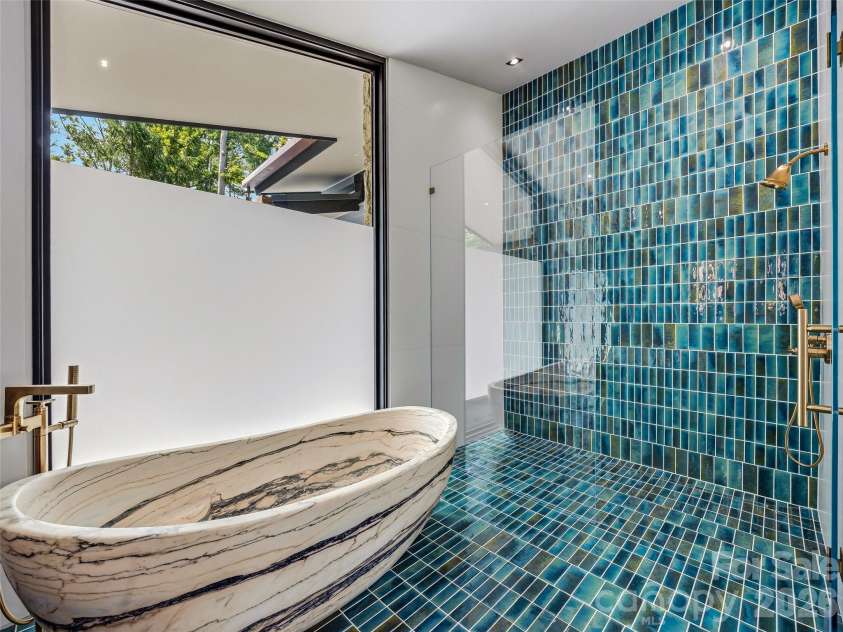 3 Holly Hill Road, Biltmore Forest, NC 28803.  MLS# CAR4396733, YatesRealty ID 32435. Floor to ceiling glazed-fired mosaic tile highlights this marble soaking tub from South Africa.
