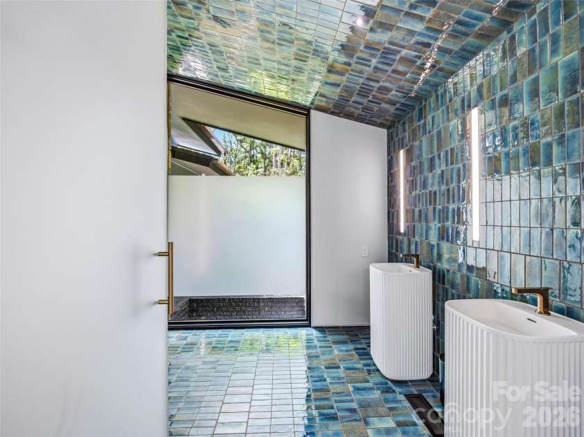 3 Holly Hill Road, Biltmore Forest, NC 28803.  MLS# CAR4396733, YatesRealty ID 32435. The guest bathroom features stacked glaze-fired mosaic tile.