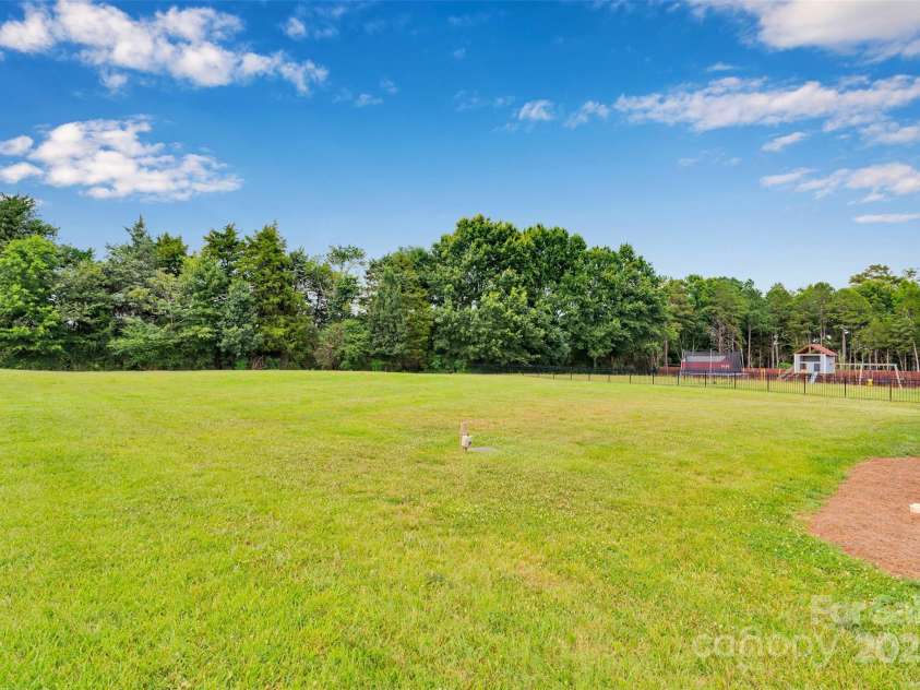 275 Dorothy Drive, China Grove, NC 28023.  MLS# CAR4275361, YatesRealty ID 32461. Rear Lot Line goes halfway through trees backing up to farmland.