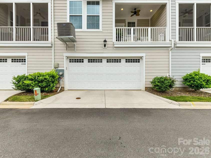 546 Amalfi Drive, Davidson, NC 28036.  MLS# CAR4390990, YatesRealty ID 32467. The attached two-car garage provides secure parking, extra storage space, and convenient direct access to the home.