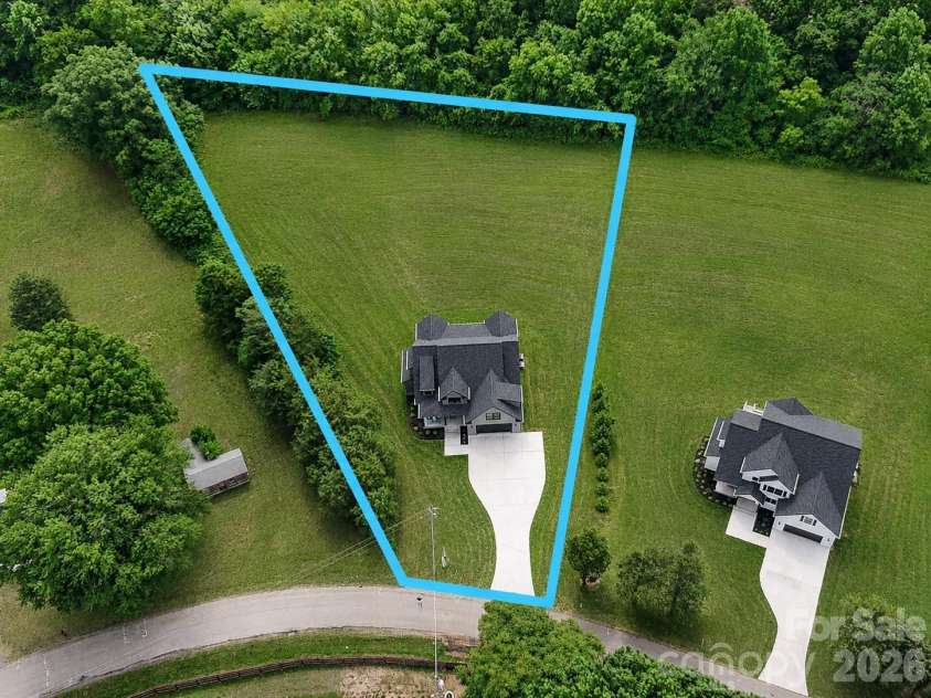 159 Lone Pine Road, Statesville, NC 28625.  MLS# CAR4385296, YatesRealty ID 32469. Concept Grass - Expansive tree-lined homesite offering exceptional privacy, a spacious backyard, and stunning aerial views in a peaceful countryside setting. Lot lines are approximate.