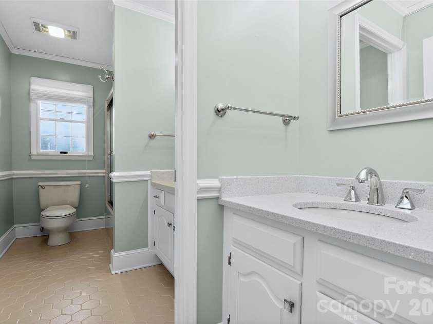 971 Stanley Lucia Road, Mount Holly, NC 28120.  MLS# CAR4388233, YatesRealty ID 32471. This large shared bathroom is generous enough in size and layout that everyone has what they need without feeling crowded — a well designed space that serves the secondary bedrooms with ease and grace.
