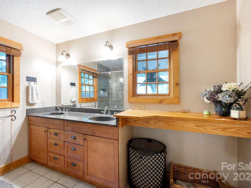 1 Buckingham Court, Asheville, NC 28803.  MLS# CAR4283545, YatesRealty ID 32483. Primary bath with additional storage spaces