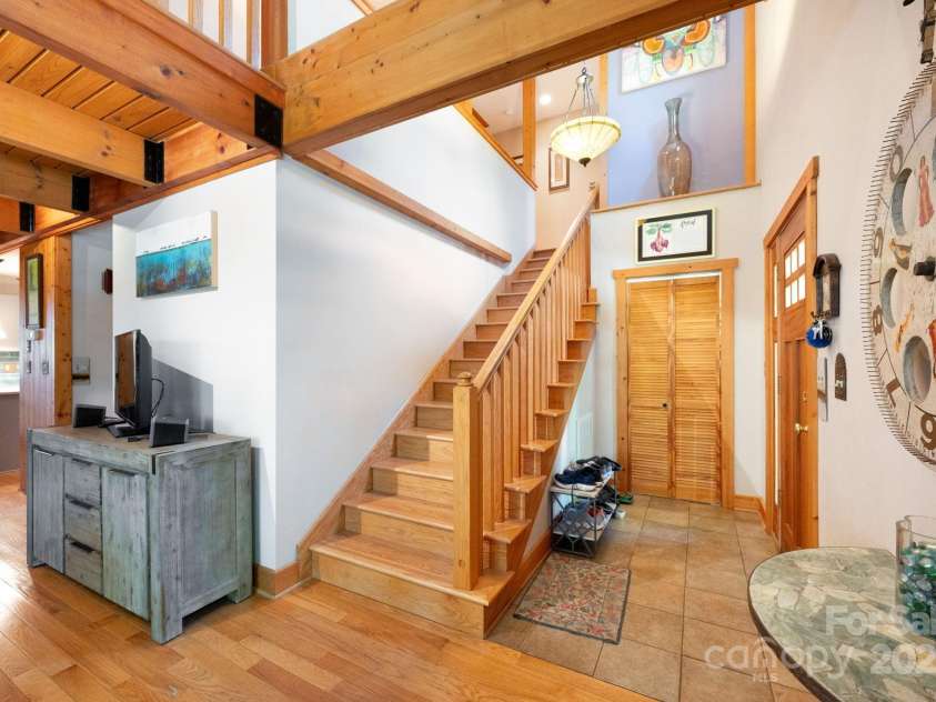 1 Buckingham Court, Asheville, NC 28803.  MLS# CAR4283545, YatesRealty ID 32483. Stairs take you to upper level beds and bath