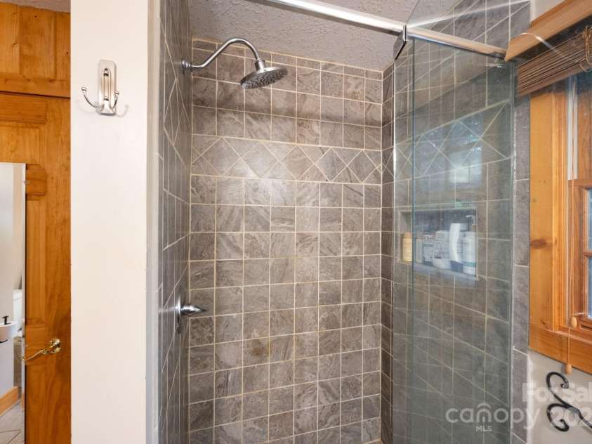 1 Buckingham Court, Asheville, NC 28803.  MLS# CAR4283545, YatesRealty ID 32483. Updated tile shower in primary