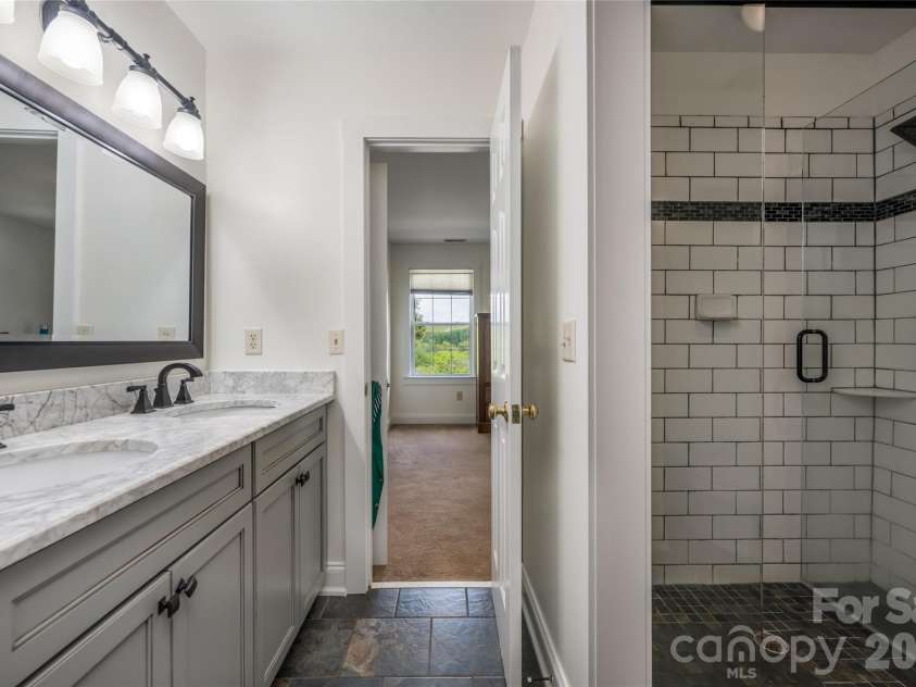 10 Lark Hill Drive, Arden, NC 28704.  MLS# CAR4395452, YatesRealty ID 32492. Shared Bath on the upper level - Updated with large walk in tile Shower and double vanity.