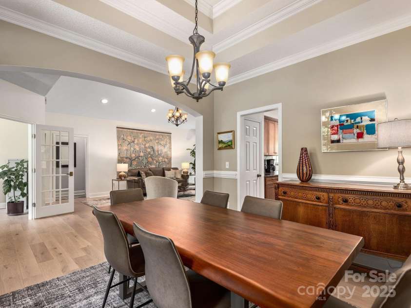 446 Charming Lane, Hendersonville, NC 28792.  MLS# CAR4287765, YatesRealty ID 32506. Arched entryway connects formal dining room to main living area while door leading to the kitchen conveniently connects the two rooms