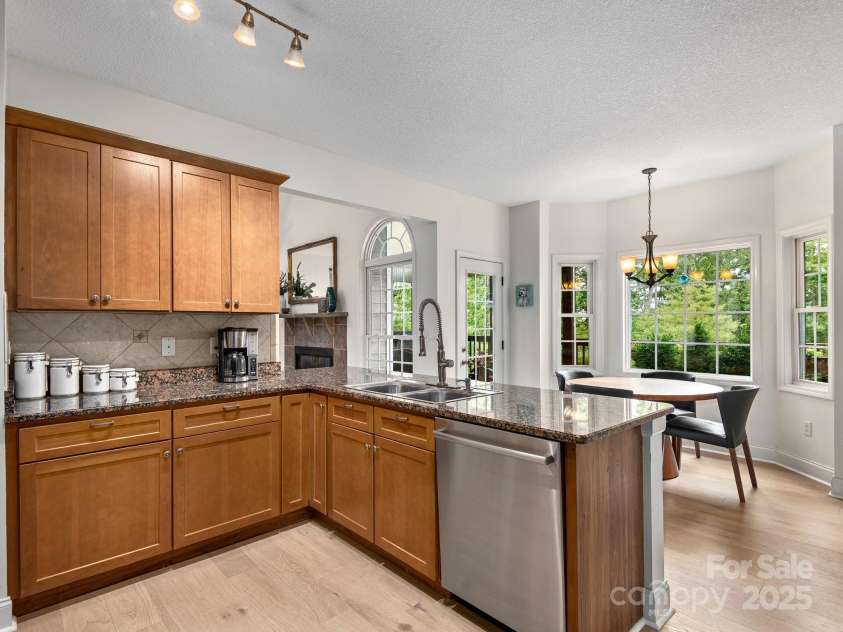 446 Charming Lane, Hendersonville, NC 28792.  MLS# CAR4287765, YatesRealty ID 32506. Convenient dining area off the kitchen to sit down for meals with peaceful views of the surrounding trees