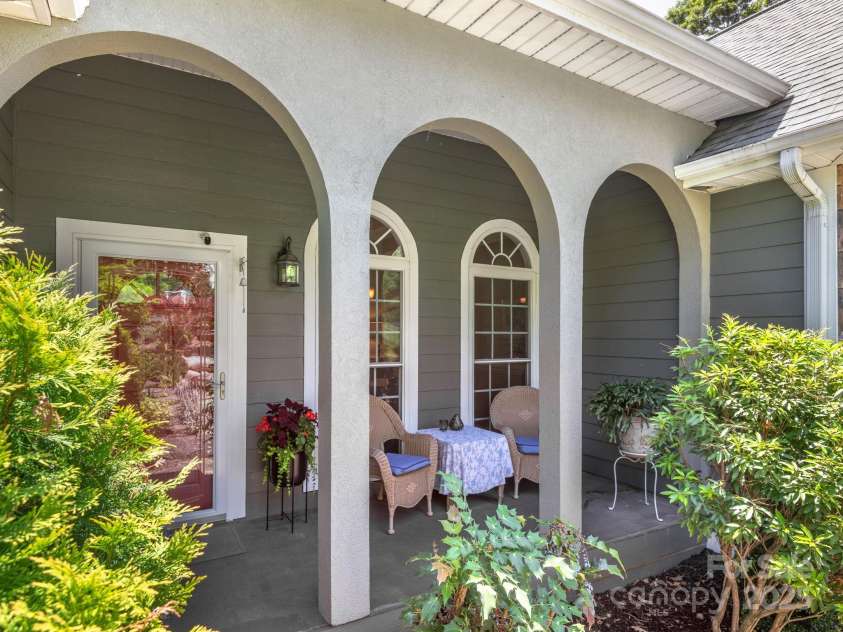 446 Charming Lane, Hendersonville, NC 28792.  MLS# CAR4287765, YatesRealty ID 32506. Covered porch offers additional outdoor living area