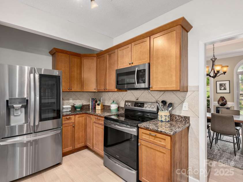 446 Charming Lane, Hendersonville, NC 28792.  MLS# CAR4287765, YatesRealty ID 32506. InstaView refrigerator and ceramic tile backsplash complete this chef's kitchen