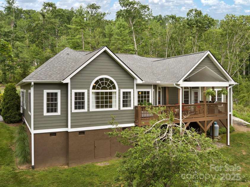 446 Charming Lane, Hendersonville, NC 28792.  MLS# CAR4287765, YatesRealty ID 32506. Large windows bring natural light indoors while the spacious deck offers generous outdoor living space