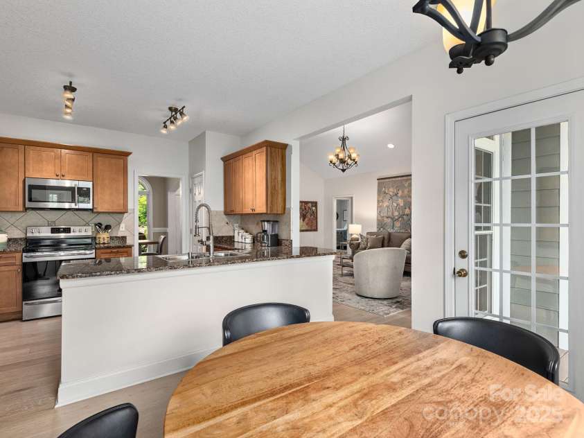 446 Charming Lane, Hendersonville, NC 28792.  MLS# CAR4287765, YatesRealty ID 32506. Light spaces flow together in a thoughtfully designed floorplan that highlights the surrounding light and natural surroundings