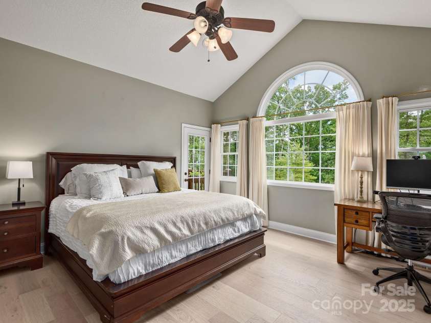 446 Charming Lane, Hendersonville, NC 28792.  MLS# CAR4287765, YatesRealty ID 32506. Peaceful primary suite features vaulted ceilings and direct access to back patio