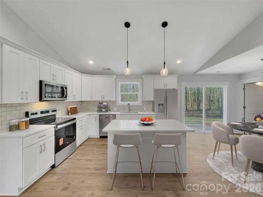 2338 Neill Road, Lancaster, SC 29720.  MLS# CAR4351976, YatesRealty ID 32515. Beautiful Kitchen with white soft close cabinets, quartz counters, and tile backsplash*virtually staged