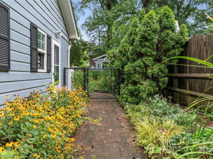 1740 Lansdale Drive, Charlotte, NC 28205.  MLS# CAR4263838, YatesRealty ID 32517. Parh to garage/workshop and fenced yard.