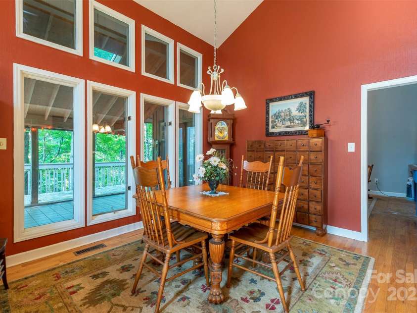 10 Chestnut Ridge Road, Mills River, NC 28759.  MLS# CAR4285429, YatesRealty ID 32518. Dining room filled with natural light and access to covered porch.