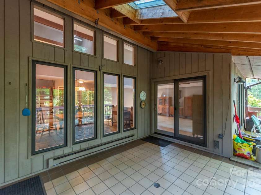 10 Chestnut Ridge Road, Mills River, NC 28759.  MLS# CAR4285429, YatesRealty ID 32518. Large Covered porch accessible from Dining Room and Living Room
