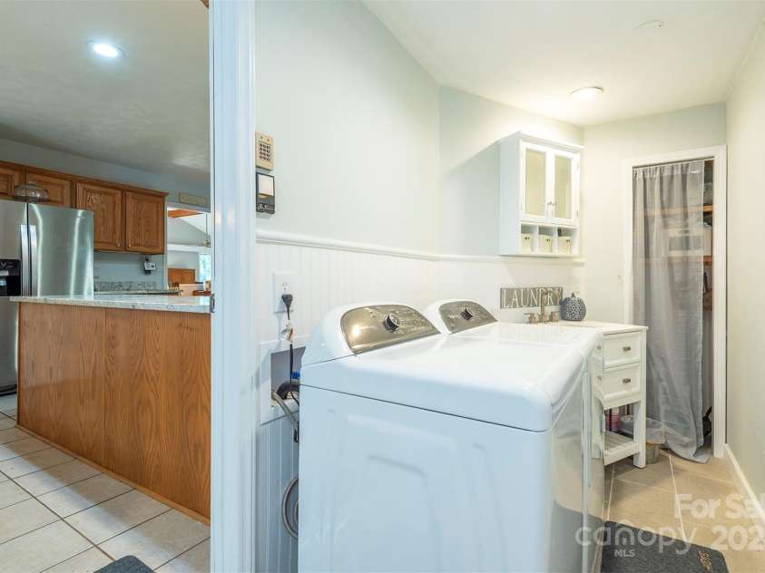 10 Chestnut Ridge Road, Mills River, NC 28759.  MLS# CAR4285429, YatesRealty ID 32518. Laundry Room on Main level - Washer and Dryer do not convey. White shelves in Laundry room do not convey.