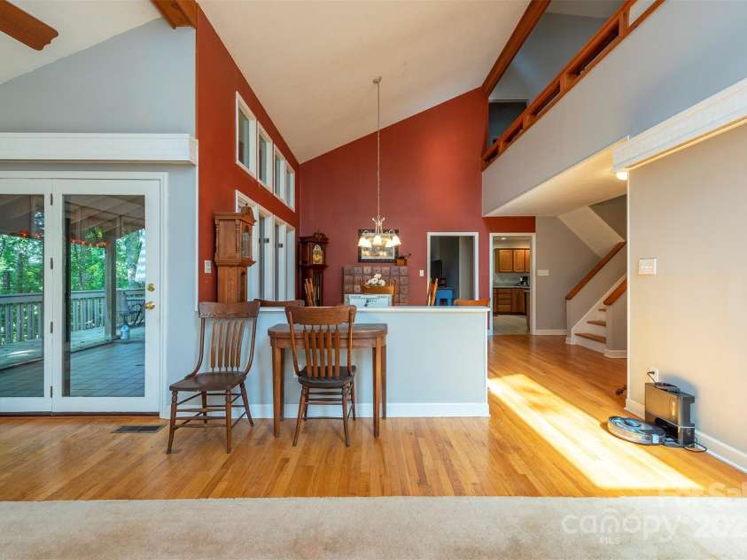 10 Chestnut Ridge Road, Mills River, NC 28759.  MLS# CAR4285429, YatesRealty ID 32518. Living room opens to a spacious wrap-around deck.